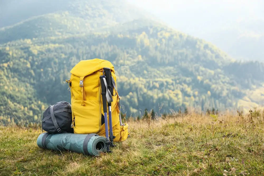 Trekking backpack with sleeping mat in the mountains